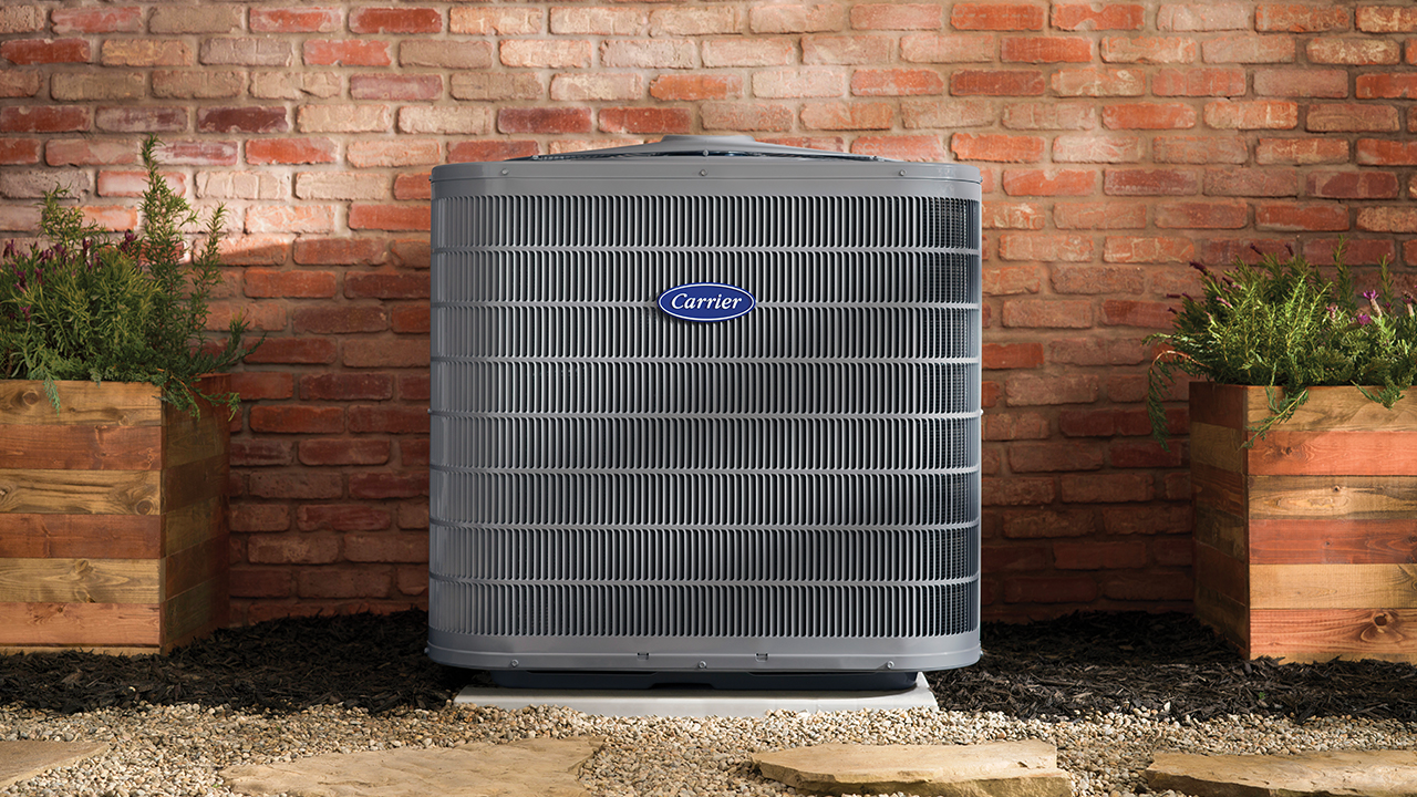 Example Carrier outdoor air conditioner beside a brick home